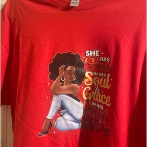A red Xl woman’s t shirt with a beautiful colorful image and message.